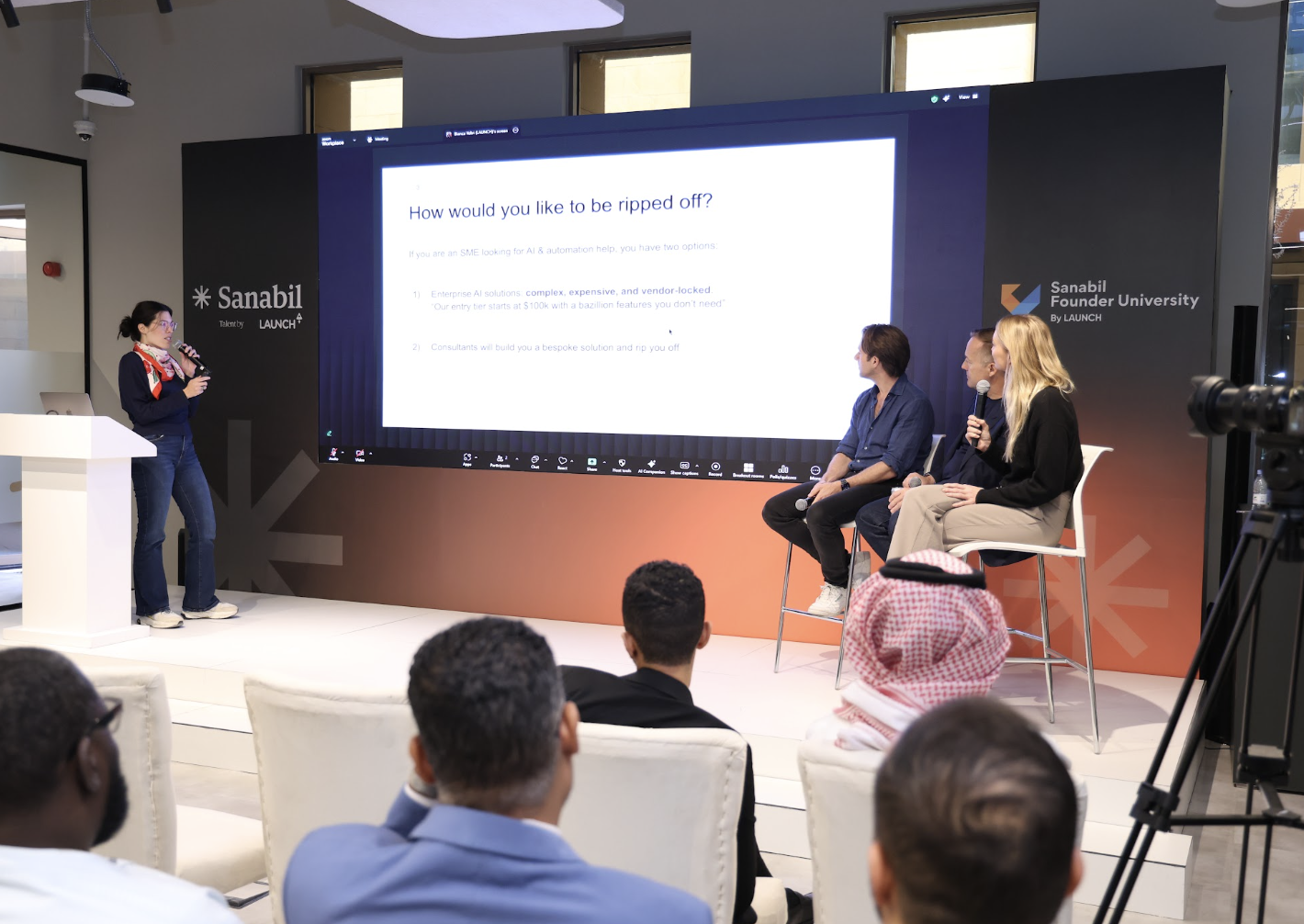 Founder presenting to a panel and audience at Sanabil Hub